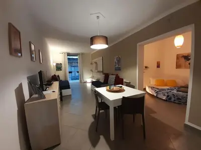 a living room with a table and a room with a couch at Casa Ranieri Palermo in Palermo