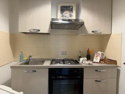 a small kitchen with a stove and a sink at Casa Ranieri Palermo in Palermo
