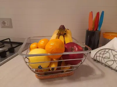 a basket of fruit sitting on a kitchen counter at Casa Ranieri Palermo in Palermo