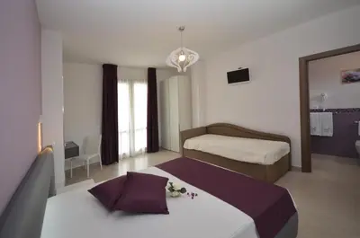 a hotel room with a bed and a mirror at Ciuri Di Mari in San Vito lo Capo