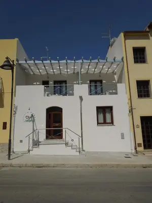 a white building with stairs on the side of it at Ciuri Di Mari in San Vito lo Capo