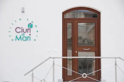 a door with a sign on the side of a building at Ciuri Di Mari in San Vito lo Capo