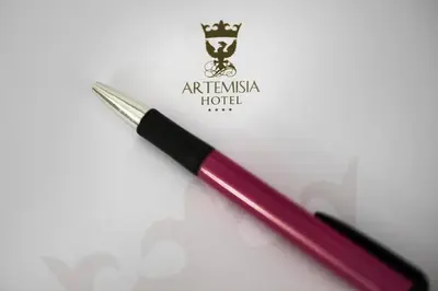 a red pen sitting on top of a piece of paper at Artemisia Palace Hotel in Palermo