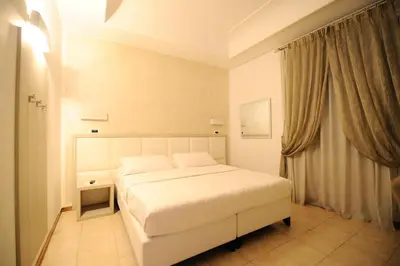 a bedroom with a white bed and a window at Artemisia Palace Hotel in Palermo