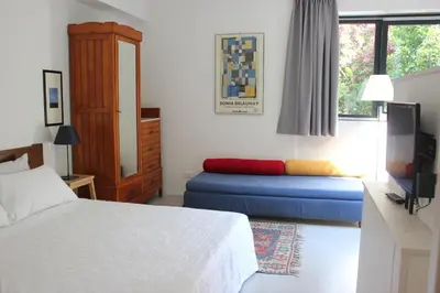 a bedroom with a bed and a blue couch at Nel Giardino degli Agrumi in Palermo