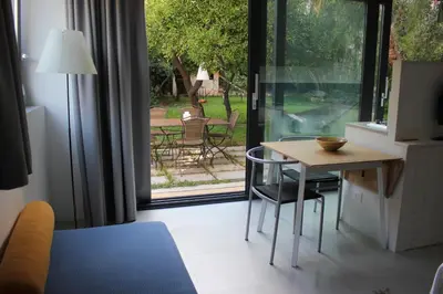 a room with a table and chairs and a sliding glass door at Nel Giardino degli Agrumi in Palermo