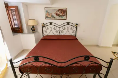 a bedroom with a bed with a red bedspread at Appartamento Piazza Pretoria in Palermo