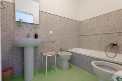 a bathroom with a sink and a toilet and a bath tub at Appartamento Piazza Pretoria in Palermo