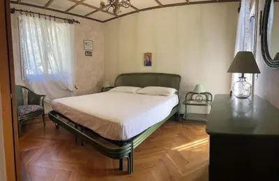 a bedroom with a bed and a table with a lamp at Villa lo Iacono in Terrasini