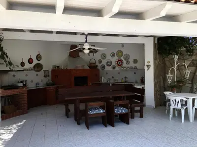 a kitchen with a wooden table and a dining room at Villa lo Iacono in Terrasini