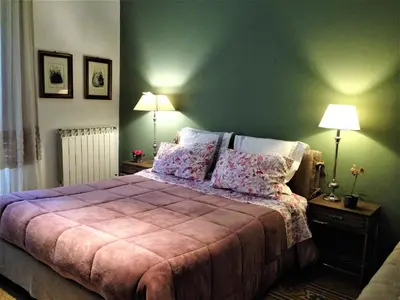 a bedroom with a bed and two lamps on tables at A Casa di Amelie in Palermo
