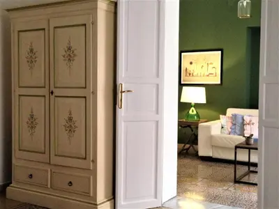 an open door to a living room with a couch at A Casa di Amelie in Palermo