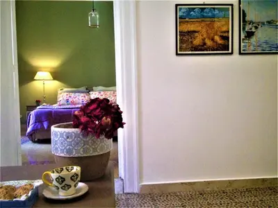 a room with a bedroom with a bed and a table at A Casa di Amelie in Palermo