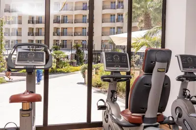 a gym with two exercise bikes in front of a window at Domina Zagarella Sicily in Santa Flavia