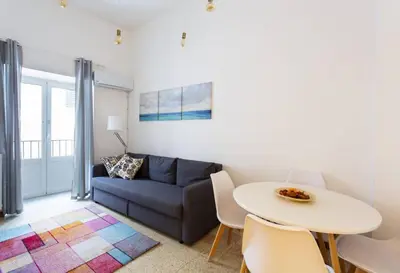 a living room with a couch and a table at BB4U Apartments and Terrace in Palermo