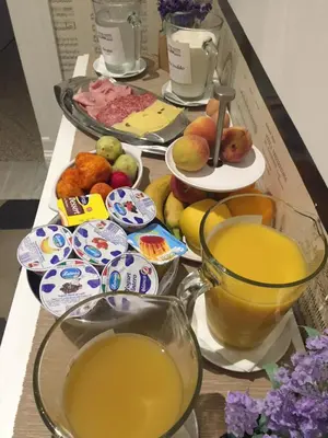 a table topped with different types of fruit and juice at L'Opera Buffa in Palermo