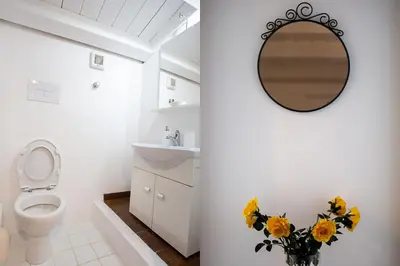 a bathroom with a toilet and a mirror on the wall at Case di Maria in Castellammare del Golfo