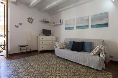 a living room with a couch and a tv at Case di Maria in Castellammare del Golfo