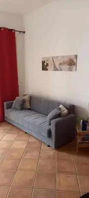 a couch sitting in a living room next to a wall at Casa Vacanze Chiara in Terrasini