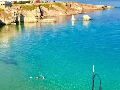 two people swimming in a body of water at Casa Vacanze Chiara in Terrasini