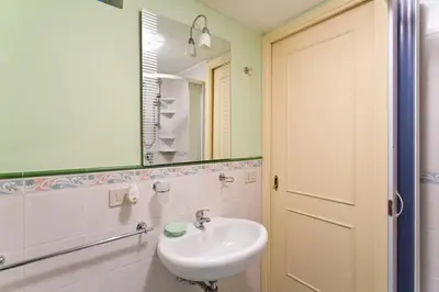 a bathroom with a sink and a mirror at Oasi Centrale in Palermo