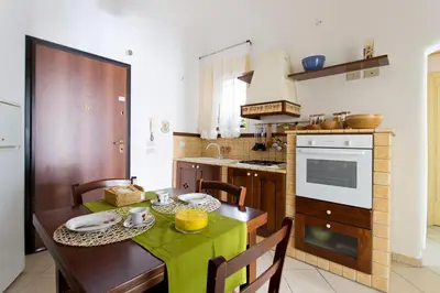 a kitchen with a table with a green table cloth at Oasi Centrale in Palermo