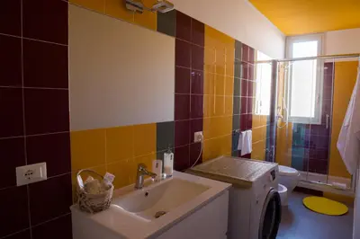 a bathroom with a sink and a toilet at Chic Apartment Le Monde in Castellammare del Golfo
