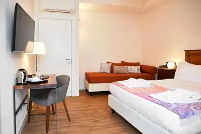 a hotel room with a bed and a desk and a bed at Sopra Le Mura in Castellammare del Golfo