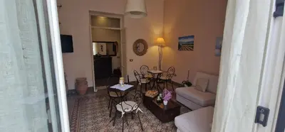 a living room with a couch and a table and chairs at Eureka in Palermo
