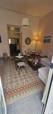 a living room with a couch and a table at Eureka in Palermo