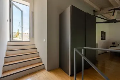 a staircase in a room with a window at Cala Loft by Wonderful Italy in Palermo
