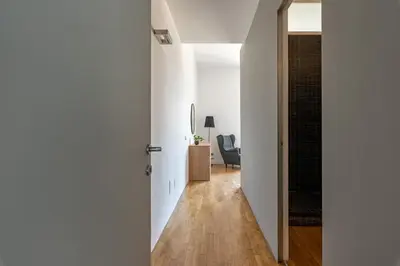 a hallway with white walls and a door leading into a room at Cala Loft by Wonderful Italy in Palermo