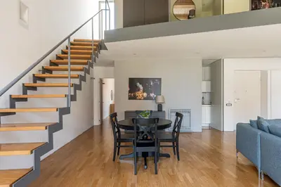 a dining room with a table and a staircase at Cala Loft by Wonderful Italy in Palermo
