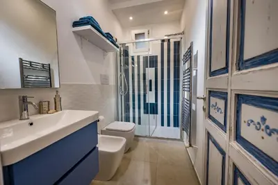 a bathroom with a white sink and a toilet at Le Perle del Golfo in Castellammare del Golfo
