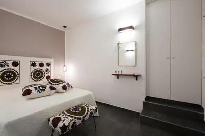 a bedroom with a bed with pillows and a mirror at Le Perle del Golfo in Castellammare del Golfo
