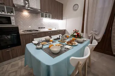 a kitchen with a blue table with food on it at Le Perle del Golfo in Castellammare del Golfo
