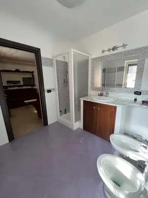 a bathroom with two sinks and a shower at Lercarappart in Lercara Friddi