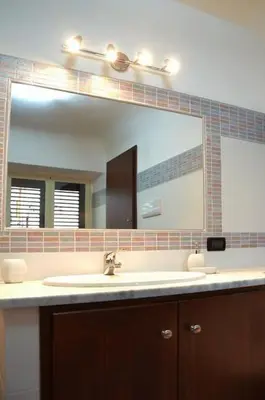 a bathroom with a sink and a large mirror at Lercarappart in Lercara Friddi