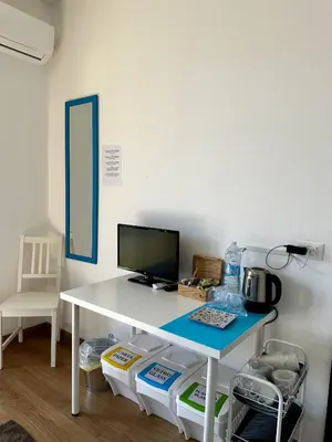 a white desk with a computer on top of it at Garden House Alla Torre in Isola delle Femmine