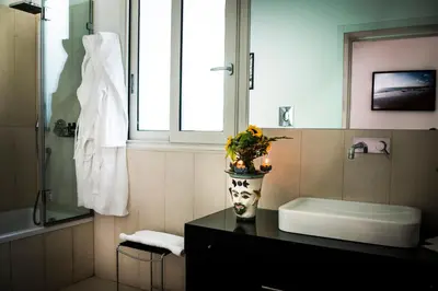 a bathroom with a vase with a face on it at Trikeles in Palermo
