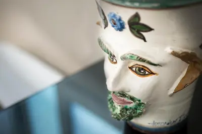 a close up of a statue of a face at Trikeles in Palermo