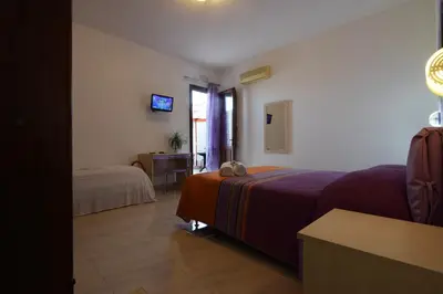 a hotel room with a bed and a table with a desk at B&B Alighieri 21 in San Vito lo Capo