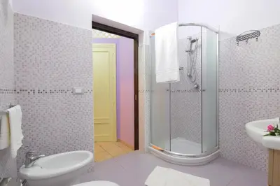 a bathroom with a toilet sink and a shower at B&B Alighieri 21 in San Vito lo Capo