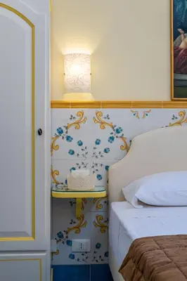 a bedroom with a bed and a table with a basket on it at Albert Rooms & Breakfast in San Vito lo Capo