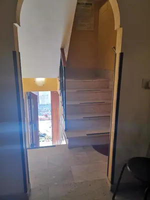 a hallway with stairs in a house with a door at Albergo Ristorante Pizzeria Del Viale in Palazzo Adriano