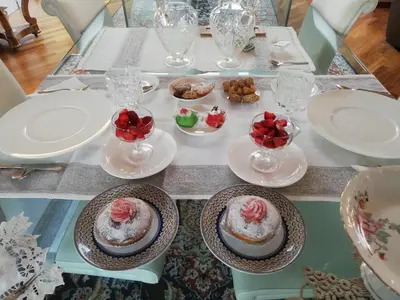 a table with cakes and plates and desserts on it at B & B Villa Flora in Mondello