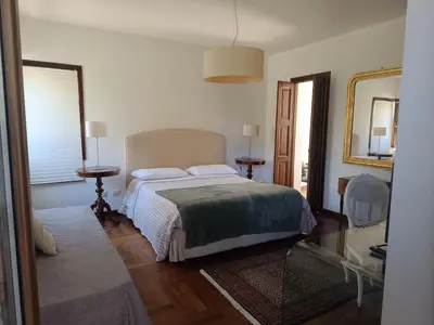 a bedroom with a bed and a mirror at B & B Villa Flora in Mondello