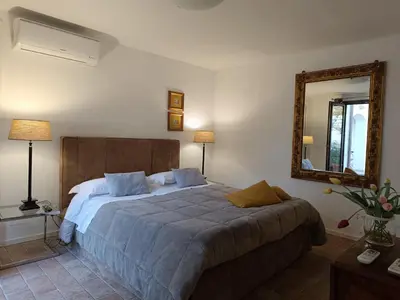 a bedroom with a large bed and a mirror at B & B Villa Flora in Mondello