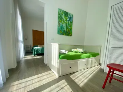 a bedroom with a bed with a green mattress at Via Siracusa 5 in Castellammare del Golfo
