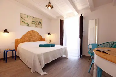a bedroom with a white bed in a room at Via Siracusa 5 in Castellammare del Golfo